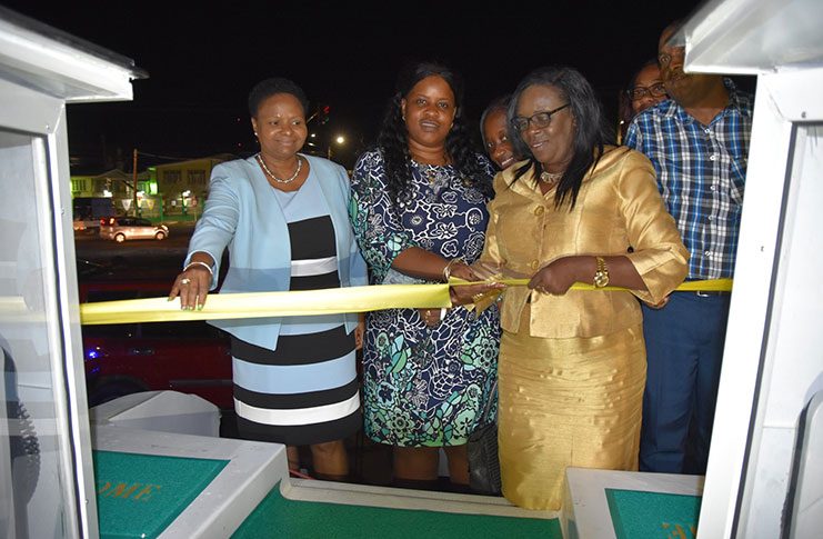 From Left to right, Minister of Public Health, Volda Lawrence; Deputy Permanent Secretary-Admin MoPH, Shellon Bess, and Permanent Secretary, Collette Adams, cut the ceremonial ribbon to commission the boat while other staff of the ministry watch on