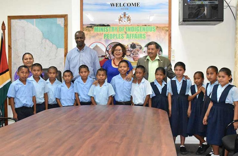 Vice President and Minister of Indigenous Peoples’ Affairs, Sydney Allicock; Minister within the Ministry, Valerie Garrido-Lowe and Permanent Secretary Alfred King pose with the students of Tuseneng Primary School.