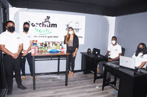 Co-owner of Gorchum Fresh, Amy Low-A-Chee (centre), with some of her employees at one of their locations (Adrian Narine photo)