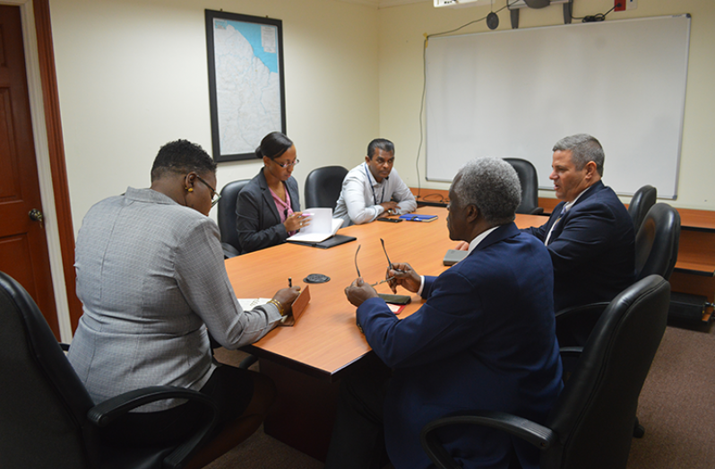 Minister within the Ministry of Public Infrastructure, Annette Ferguson, meeting with Matthew Cummings, a representative of the Transport Security Administration (TSA) and other local aviation officials