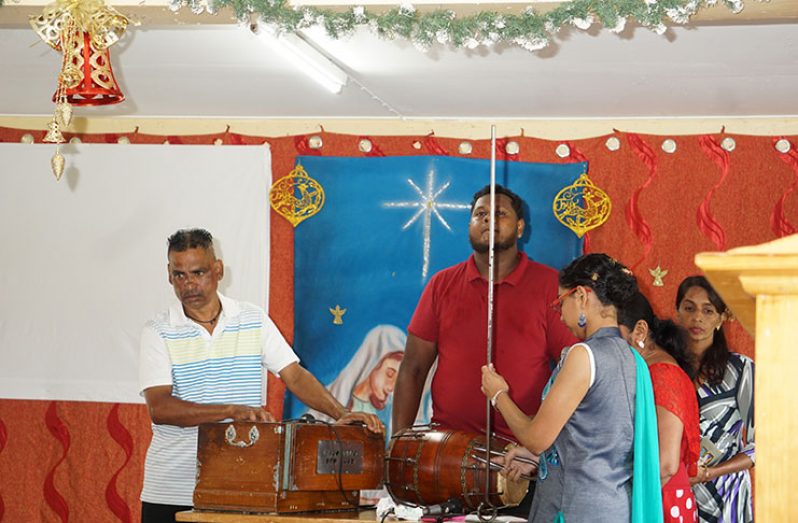 Members of the Cummings Lodge Mandir perform a song