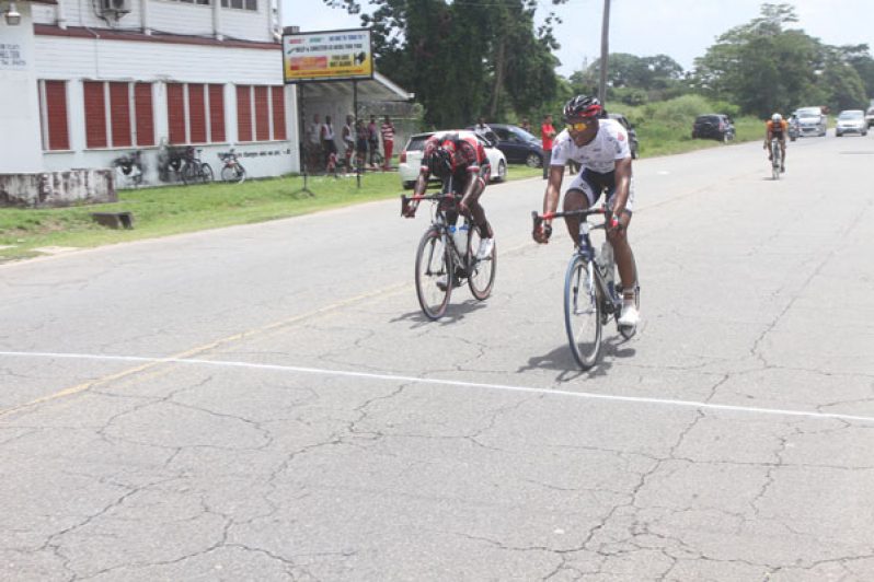 Michael Anthony (right) edges Hamza Eastman to the line, winning the Victor Macedo 12th annual 70-mile memorial cycle road race yesterday. (Sonell Nelson photo)