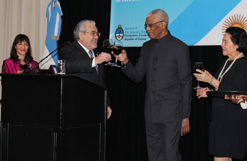 President David Granger and First Lady Sandra Granger toast to Argentina’s independence with Argentine Ambassador to Guyana, Dr. Felipe Alejandro (second from left) and wife Magdalena Mandiola de Gardella (Vishani Ragobeer photo)