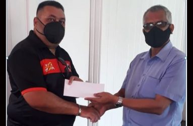 Jandoo Singh, Admin Asst. of David Persaud Investments Limited (at right) hands over the sponsorship cheque to chairman of BMC, Raj Singh.
