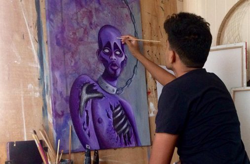 Guyanese artist Roberto Teekah, painting a portrait