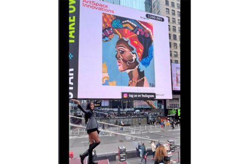 Brittany "Brigitte" Davis stands proudly next to her artwork (Image via Facebook, Brigitte Davis)