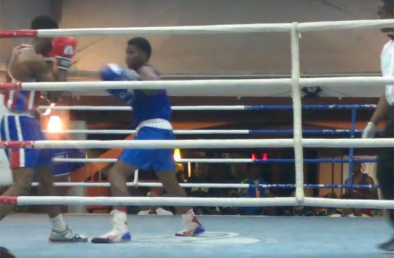 ATTACK: Guyana’s Demsond Amsterdam (right) on the attack against Barbados’ Ision Fraser in their middleweight bout at the CDBT in Barbados.