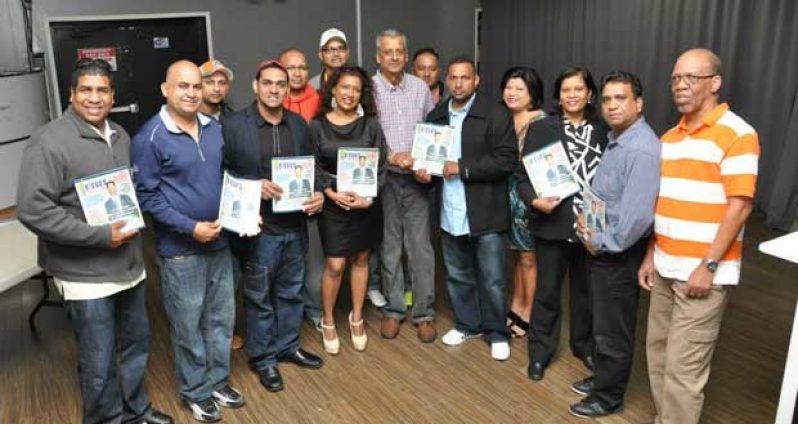 ATTENDEES at Saturday’s launching pose with copies of the magazine. (Picture courtesy Bobby Ramlagan)