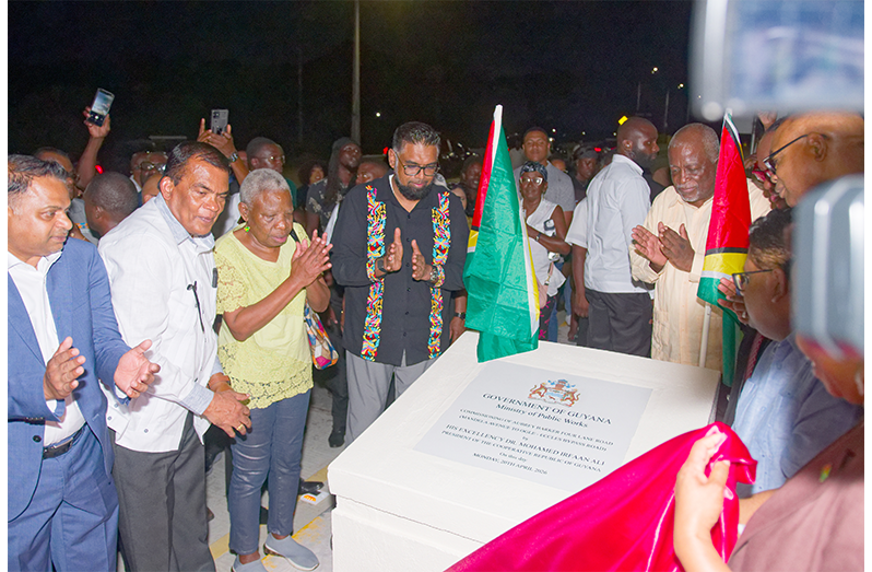 President Dr Irfaan Ali unveils the plaque following the commissioning of the Aubrey Barker Four lane road (Delano Williams photos)