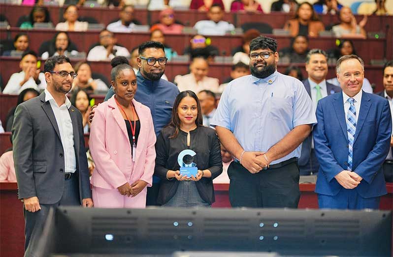 Minister of Public Service, Government Efficiency and Implementation Zulfikar Ally; President Dr. Irfaan Ali; and Coursera’s Vice-President Zac Rule were joined by several young public servants to receive the Regional Talent Transformation Award on Monday (Delano Williams photo)