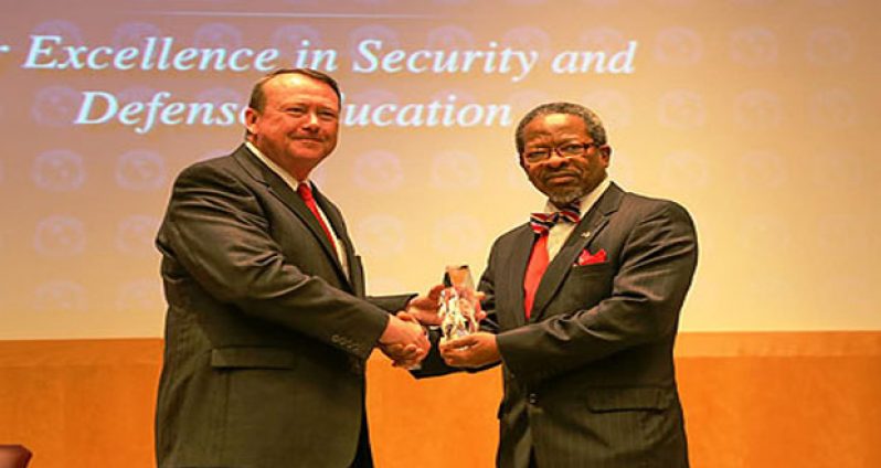 Mr. Mark Wilkins, Director, Perry Center (left), presents the 2015 William J. Perry Award for Excellence in Security and Defense Education to Dr. Ivelaw Griffith