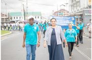 Minister of Labour, Joseph Hamilton and Minister of Human Services and Social Security, Dr. Vindhya Persaud, lead the child labour awareness walk on Thursday (Delano Williams photo)