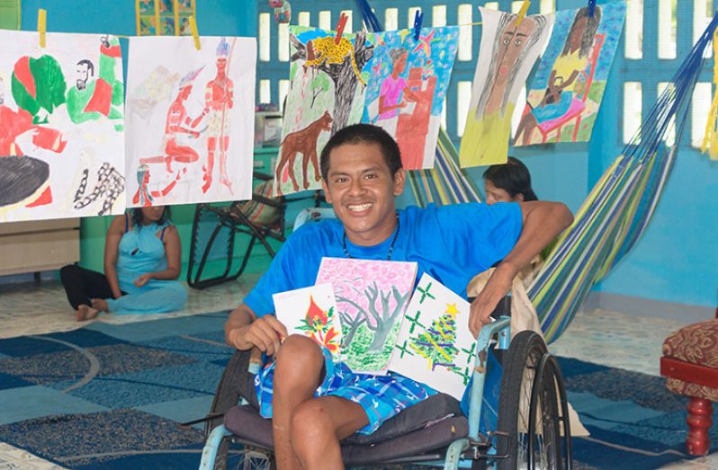 Carey Baird showing off some of his artwork
