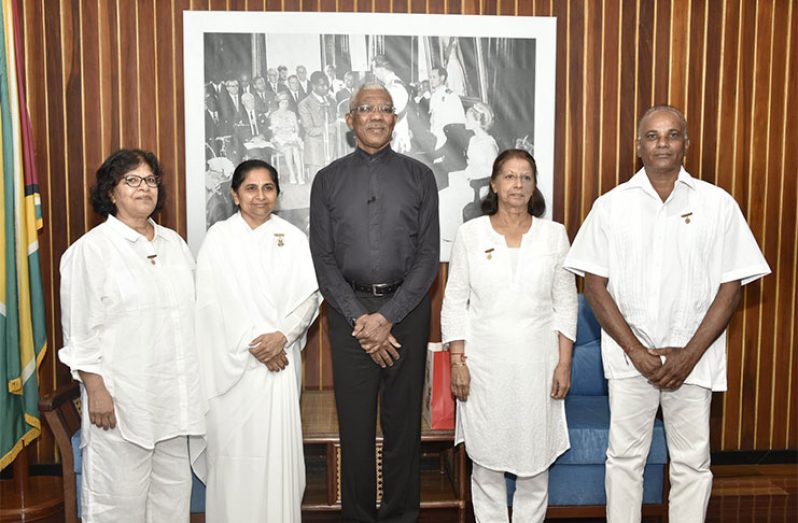 President David Granger (centre) with Ms. Paramdai Persaud, Ms. Sita Narine and Mr. Stanley Singh of the Brahma Kumaris Raja Yoga Centre, Wednesday morning, at the Ministry of the Presidency