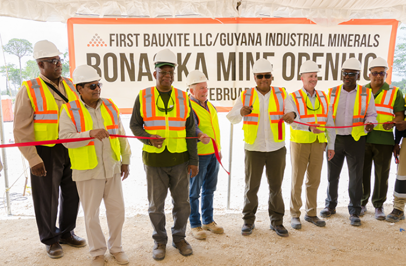 Minister of Natural Resources, Raphael Trotman (fourth from right) cuts the ceremonial ribbon marking the opening of operations at the GINMIN, a subsidiary of First Bauxite. Also in the picture (from left) are GGMC Commissioner, Newell Dennison; Prime Minister, Moses Nagamootoo; and Minister of Finance, Winston Jordan (Delano Williams photo)