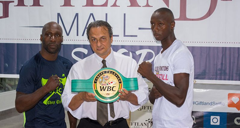 DeMarcus `Chop Chop’ Corley (left) and Dexter `The Cobra’ Gonsalves (right, strike a pose with GBBC president Peter Abdool who shows off the WBC’s FECABOX lightweight belt that will be up for grabs tomorrow night. (Photo by Samuel Maughn)