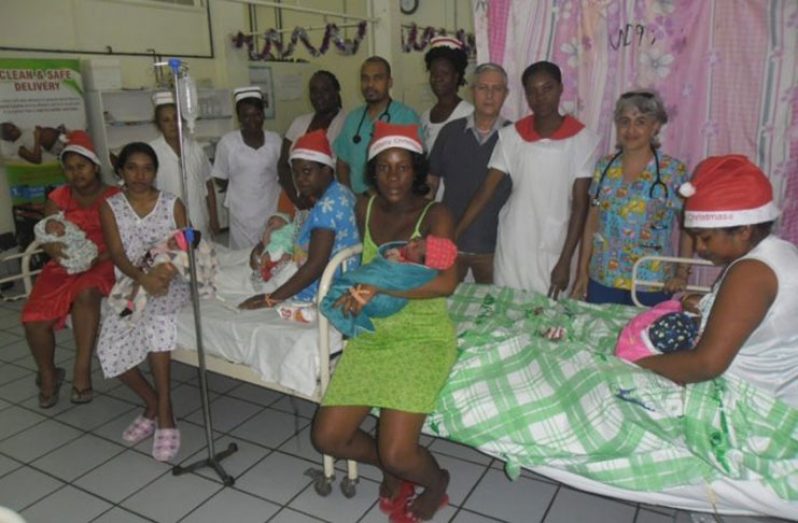 The Christmas Day mothers, along with medical staff, pose for the media on Thursday