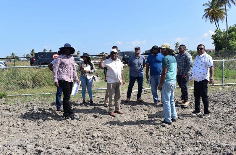 Minister Singh inspects a community ground in Berbice