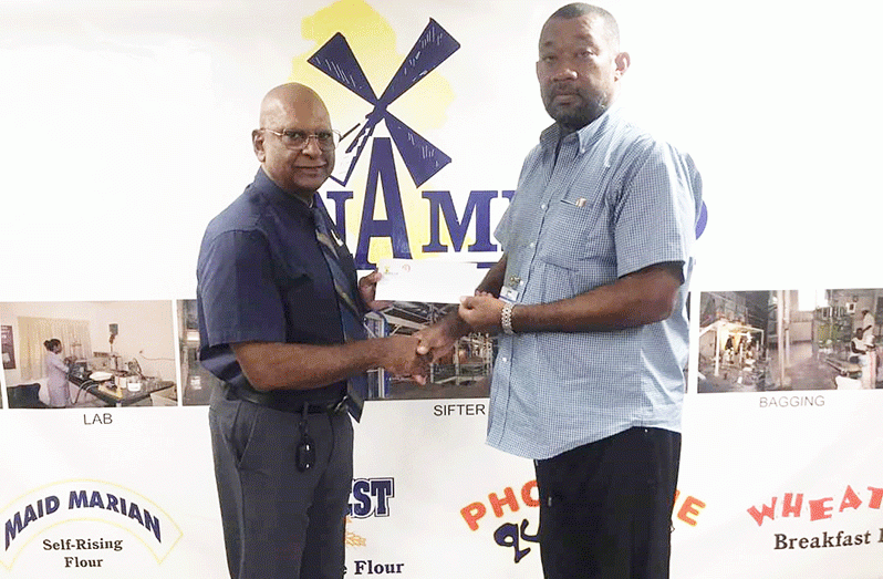 NAMILCO Managing Director, Bert Sukhai, hands over sponsorship to RHTYSC Secretary /CEO Hilbert Foster