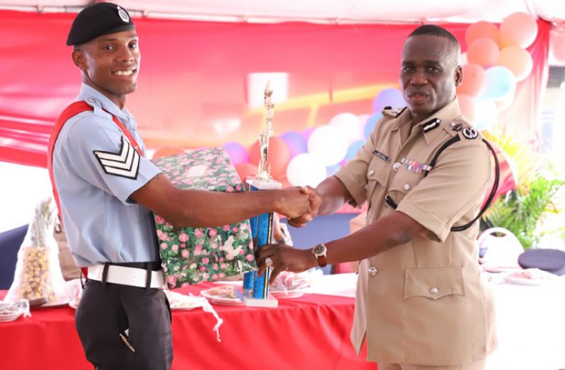 Best Cop, Sergeant Clive Clarke receiving tokens from Commissioner of Police, Leslie James