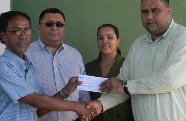 W&H Rambaran Mariner Outboard Engines manager Bharrat Singh hands over the sponsorship cheque to DCB treasurer Anand Kalladeen in the presence of DCB president and administrator, Raj Singh and Melinda Bishundyal.