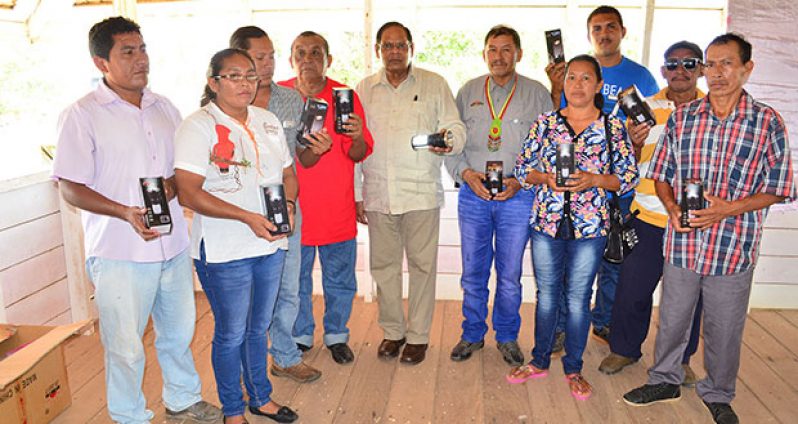 Prime Minister Moses Nagamootoo and Minister of Indigenous People’s Affairs, Vice President Sydney Allicock, pose with NRDDB executives and village representatives who were presented with solar LED lights (OPM photo)