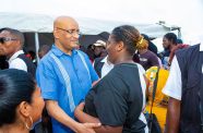 Vice-President Dr Bharrat Jagdeo interacts with a resident of Sophia (Shaniece Bamfield photo)