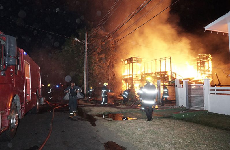 Firefighters putting out the blaze on Anira Street, Queenstown, Georgetown on Tuesday evening (Carl Croker photo)