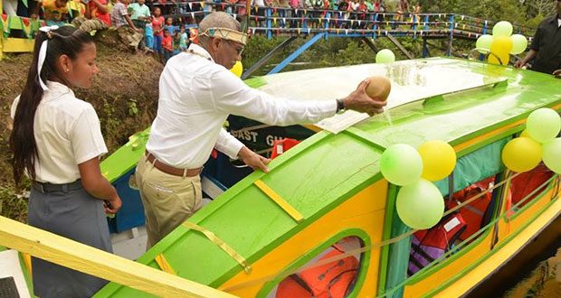 President David Granger pours coconut water on the newly commissioned boat