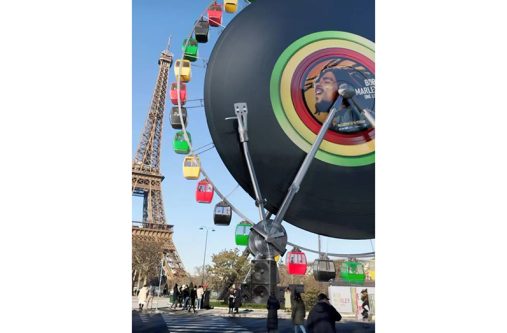 This giant Ferris Wheel at Place de la Concorde bleeds black, red, green, and gold in celebration of the ‘Bob Marley: One Love’ February 14 release (Photo: IG/paramountpicturesfrance)