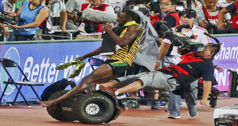 Usain Bolt of Jamaica is hit by a cameraman on a Segway as he celebrates after winning the men's 200 metres final at the 15th IAAF World Championships at the National Stadium in Beijing, China. (Reuters/Stringer)