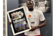 Olympian-turned-music producer Usain Bolt displaying his Billboard plaque for Country Yutes