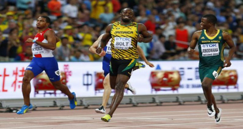 Usain Bolt of Jamaica (C) runs past Roberto Skyers of Cuba and Anaso Jobodwana of South Africa (R) to win their men's 200 metres semifinal.