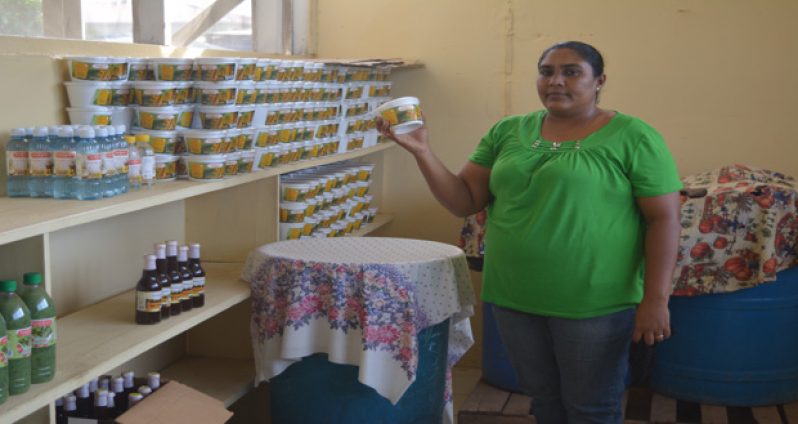 Hafeeza Rasheed holds up one of the products sold by The Pomeroon Women’s Agro-Processors Association