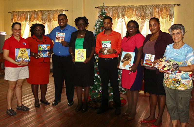 Veronica (extreme left) pose with representatives of the organisations to which books were donated and her local support team