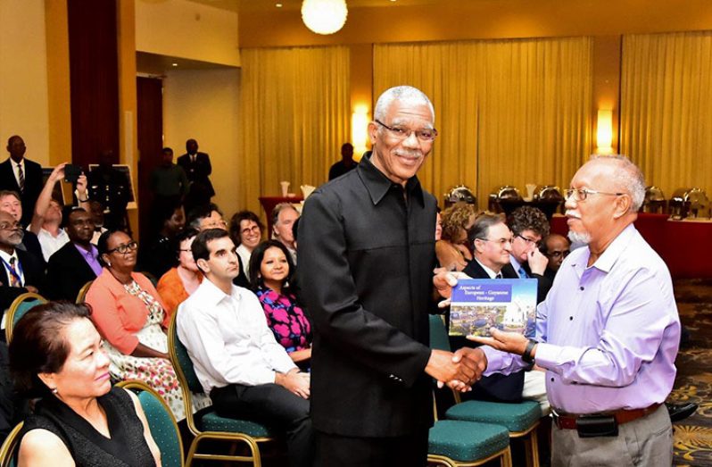 President David Granger receiving his copy of ‘Aspects of European-Guyanese History’ from Chairman of the National Trust of Guyana, Mr. Lennox Hernandez