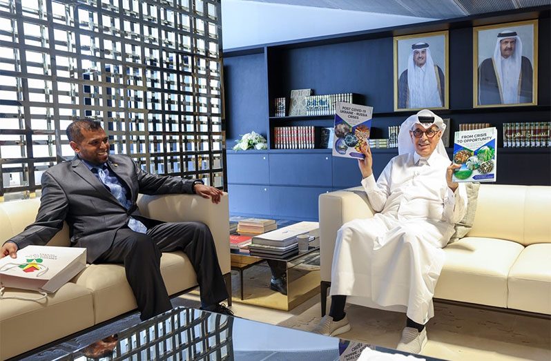 Dr. Hamad Bin Abdulaziz Al-Kuwari, Minister of State and President of the Qatar National Library displays the two books as Guyana’s Ambassador to Qatar, Safraaz Ahmad Shadood, looks on