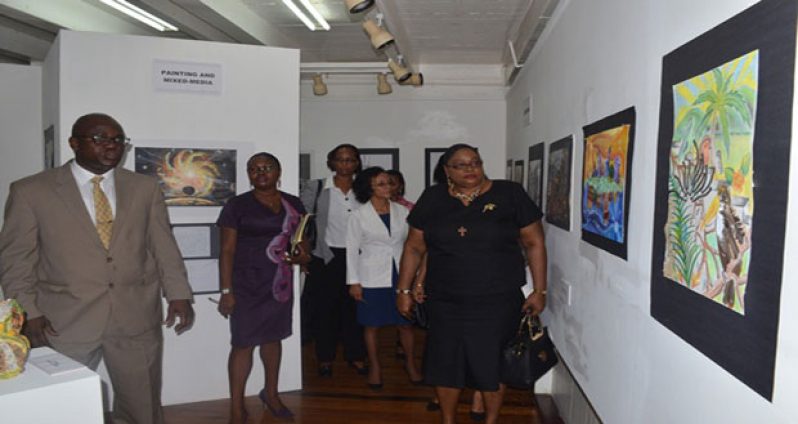 Chief Education Officer, Olato Sam and Technical Assistant to the Minister of Education and Coordinator of the School Boards Secretariat, Melcita Bovell viewing one of the displays at the exhibition