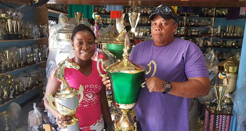 In photo Tiana lovell of Trophy Stall handing over the champion jockey trophy along with the President’s  Cup to Wayne Campayne of Rising Sun Turf Club..