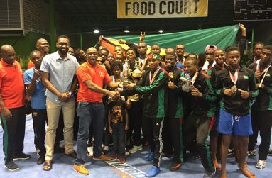 President of the Guyana Boxing Association Steve Ninvalle (fourth Left) presents 2018 Caribbean Boxing Championship `Best Boxer, Keevin Allicock with his accolade in the presence of Director of Sports, Christopher Jones (third left) and other members of the Guyana team.