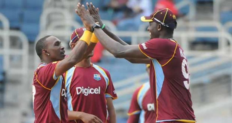 Man-of-the-Match  Dawyne Bravo is being congratulated by Jason Holder after collecting one of his three wickets. (Windiescricket photos)