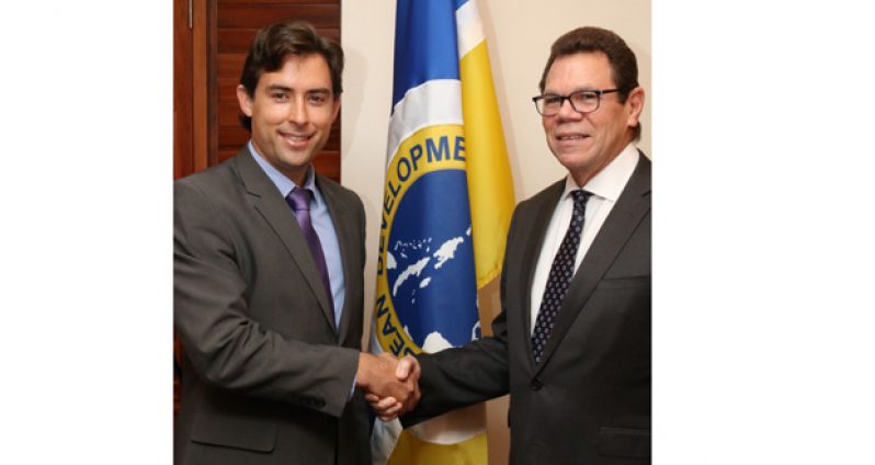 Rafael Ranieri (left), Brazil’s Alternate Director to the CDB, is greeted by Dr. Warren Smith (right), President, CDB