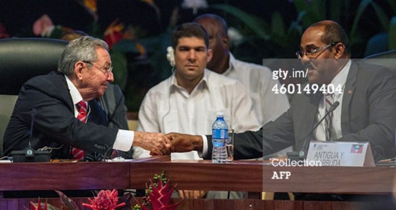 Cuban President Raul Castro (L) and Antigua and Barbuda's Prime Minister Gaston Browne shake hands during the opening of the Caribbean Community (CARICOM) Summit, in Havana, on December 8, 2014