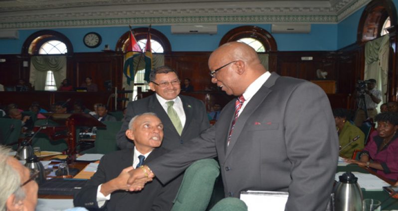 Finance Minister Winston Jordan greeting Communities Minister Ronald Bulkan as Minister of Indigenous People’s Affairs, Sydney Allicock, looks on