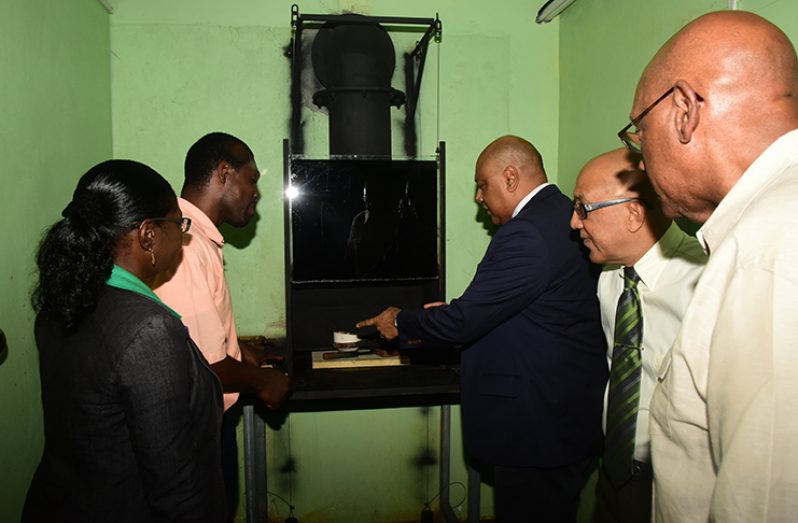 General Manager of the Guyana Gold Board, Eondrene Thompson, showing Minister of Natural Resources, Raphael Trotman, the new burning room
