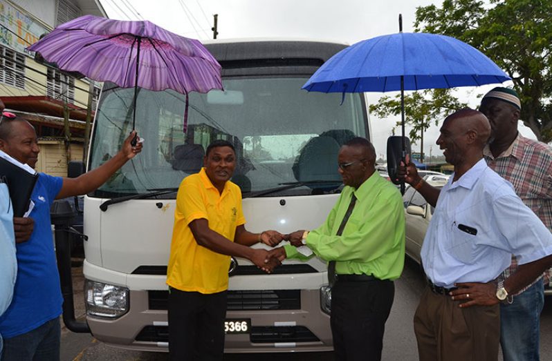 Regional Chairman Renis Morian handing over the keys to the bus to Regional Education Officer Rabindra Singh