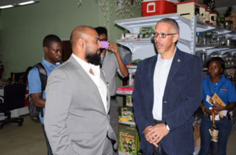 Minister of Business and Tourism, Dominic Gaskin, speaking with a representative of Beepat’s Store on Regent St.