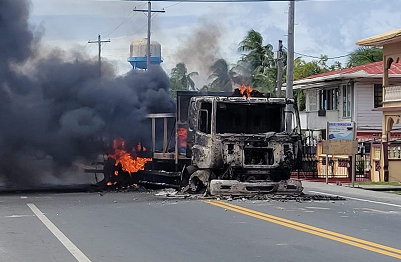 A container truck that was set ablaze during the unrest