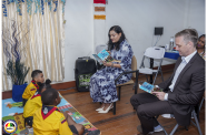 Minister of Human Services and Social Security, Dr Vindhya Persaud and Political and Economic Counselor of the U.S. Embassy, Russell Zalizniak, reading the child-friendly TIP story book to children at the launch