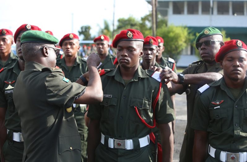 Chief-of-Staff of the GDF, Brigadier Patrick West, decorating a newly promoted rank to an ensign